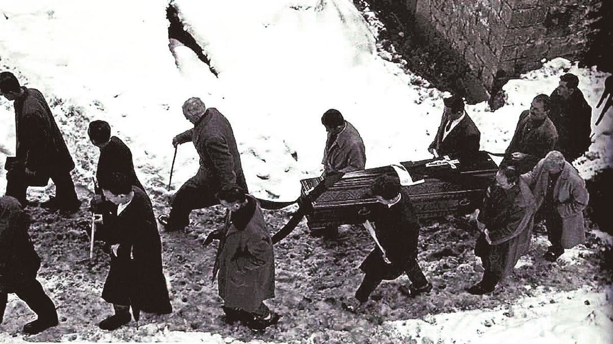Un entierro en el Valle de Valdeón en el año 1964, los vecinos llevan la caja con el cadáver y acompañan al muerto y a la familia. | MANUEL MARTÍN