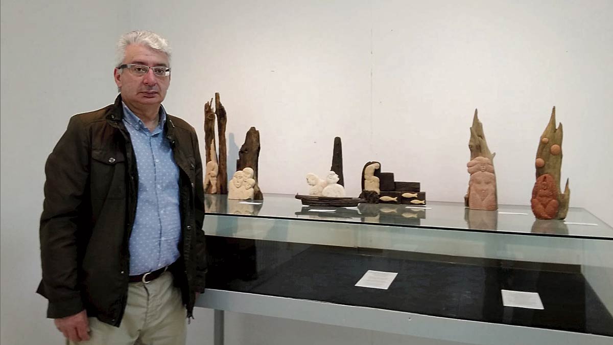 Jesús Antonio Martínez Lombó delante de algunas de las piezas de la exposición ‘Maderas a la deriva’, que se puede visitar en la biblioteca de Astorga.