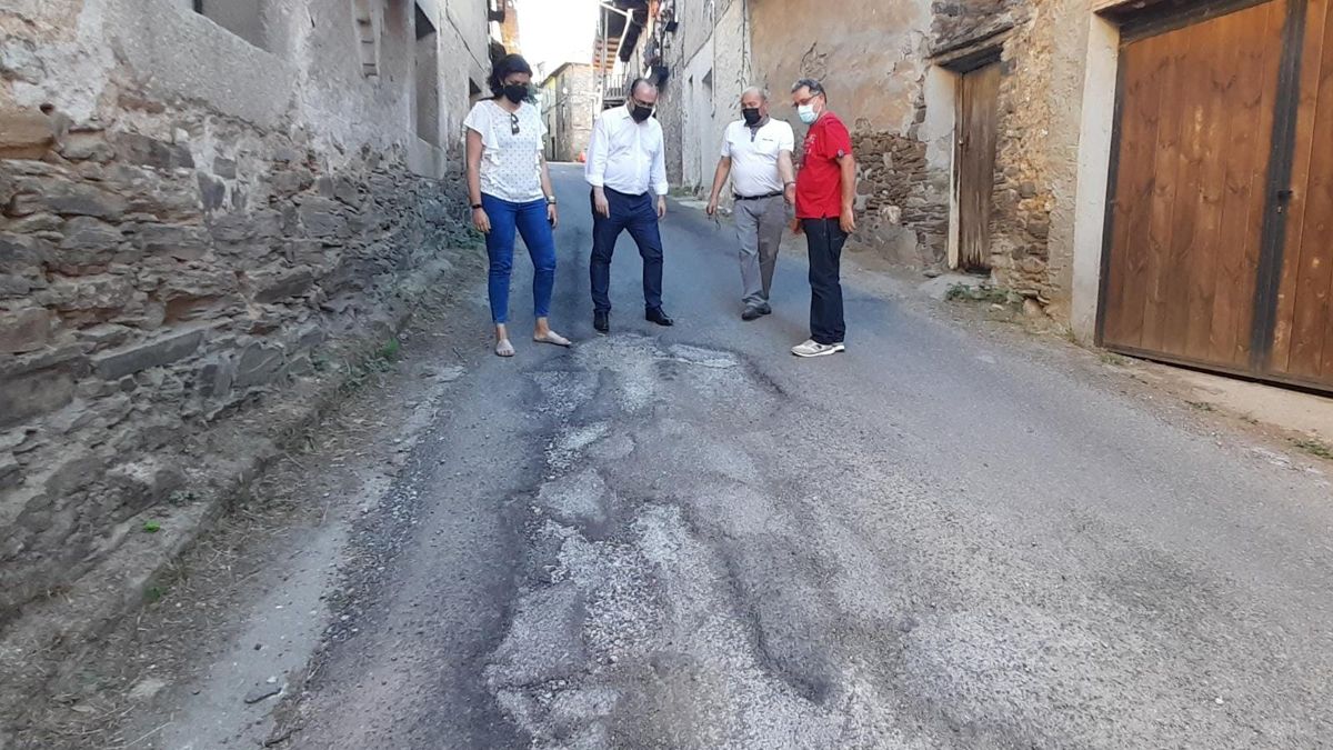 Los concejales del PP en su visita a Los Barrios, observan el deterioro de una calle.