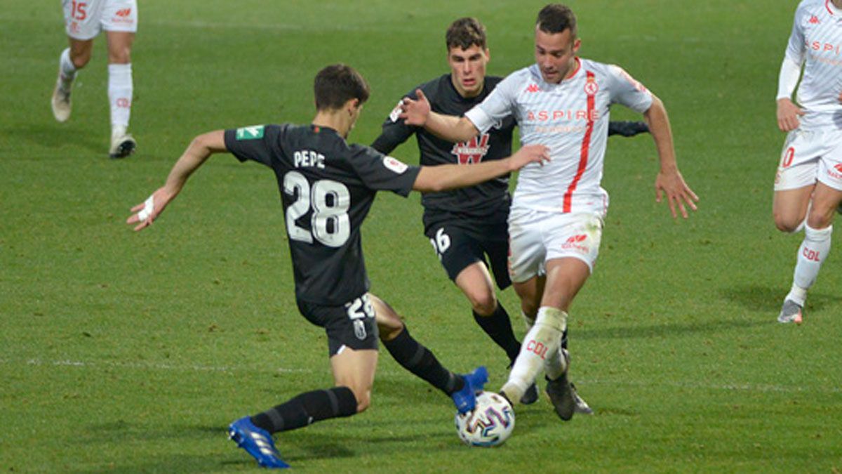Rovirola se zafa de dos rivales del Granada durante el choque ante un Primera del año pasado. | MAURICIO PEÑA