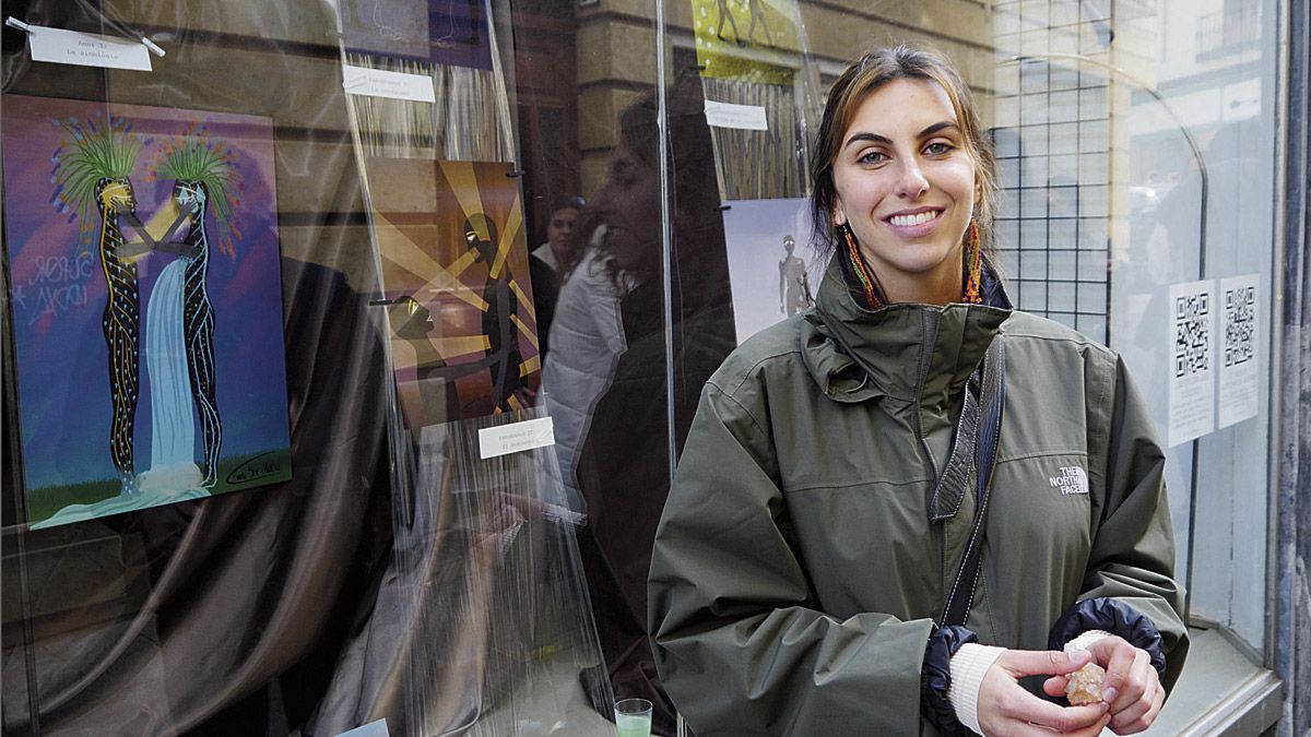 Carla Díaz ante el escaparate que muestra sus dibujos cargados de simbología. | VICENTE GARCÍA