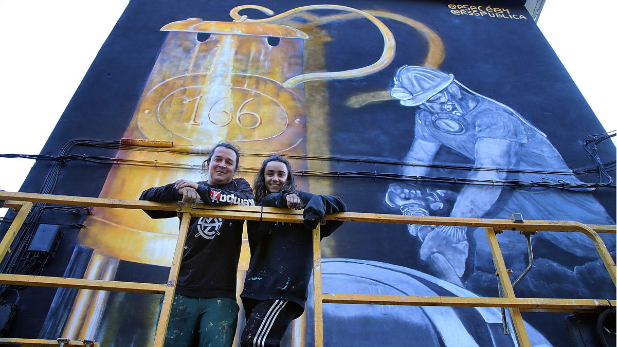 Los dos artistas finalizando el nuevo mural en la localidad. | ICAL