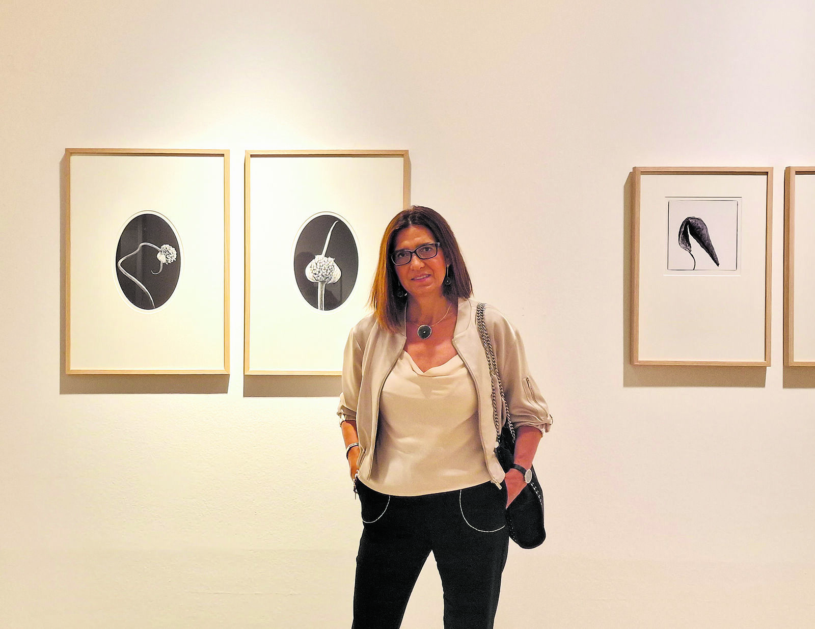 La fotógrafa leonesa Julia González Liébana ante algunas de las fotografías que conforman la exposición ‘Herbarium evanescente’. | L.N.C.