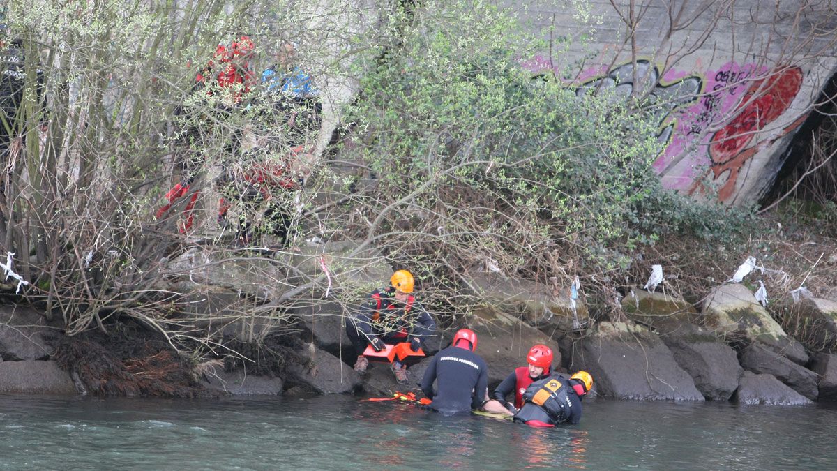 Los bomberos sacan del Sil el cuerpo sin vida del menor arrollado por las aguas. | CÉSAR SÁNCHEZ (ICAL)