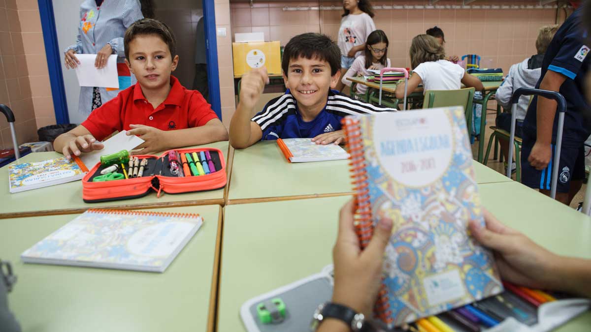 Un alumno de infantil sostiene uno de los libros en una clase. | ICAL