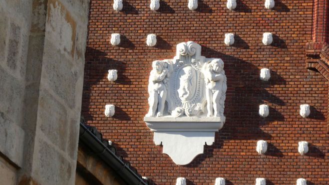 Niños angelotes y el escudo de León, rodeados de conchas, por la plaza de San Marcelo. G.F.C.