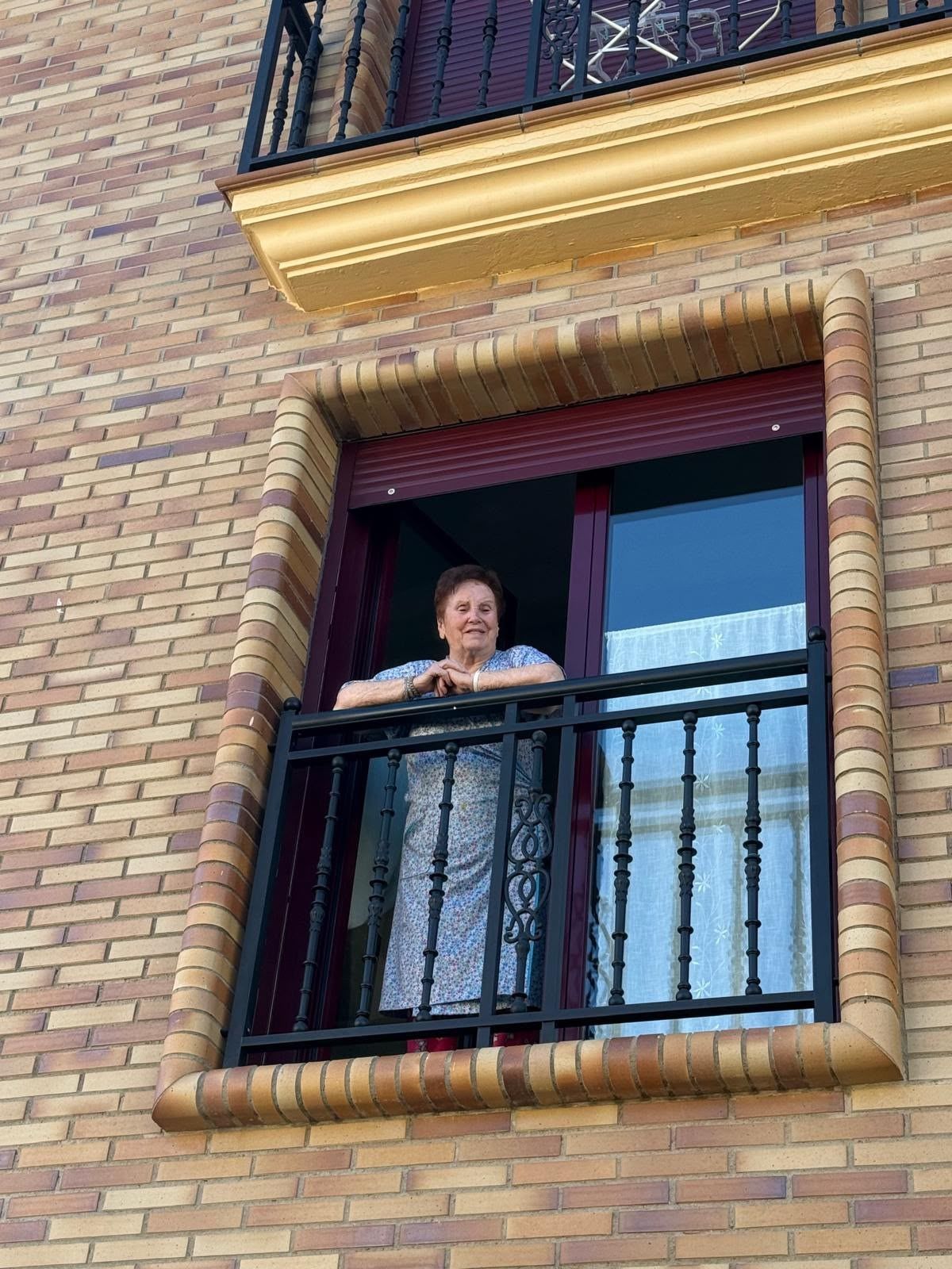 Imagen de Aurora mirando a la calle desde la ventana de su casa en Boñar. | L.N.C.