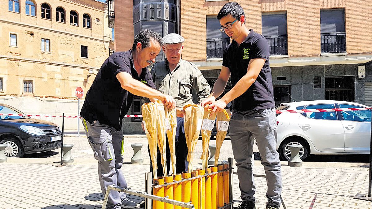 Julio, en el centro, preparando los cohetes ayer en el Parque de Valderas. | T.G.