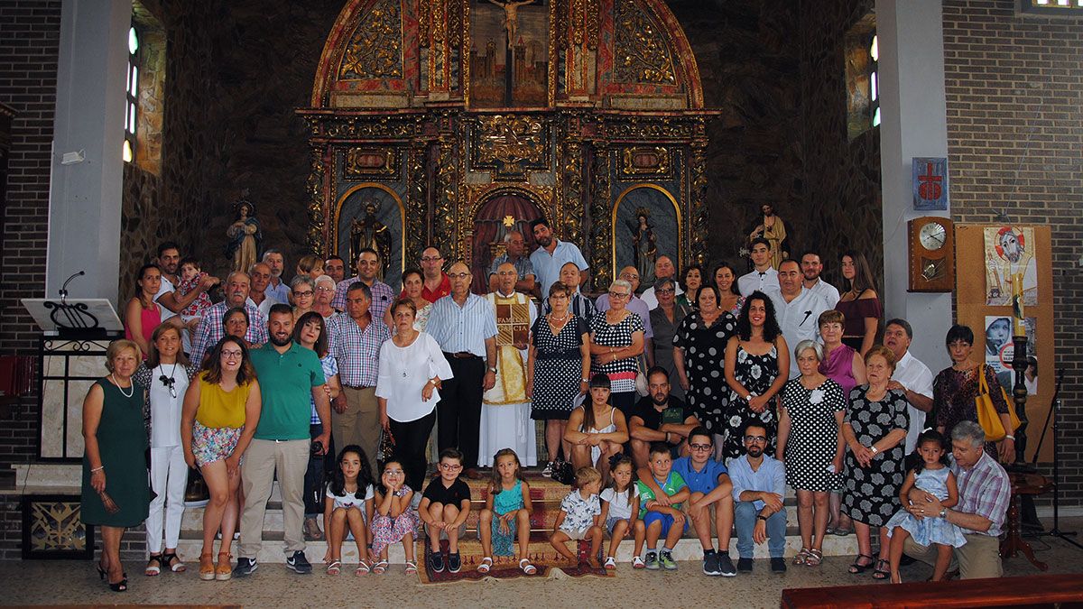 El padre Eugenio posa con buena parte de su familia en el interior de la iglesia de Requejo, donde fue bautizado y celebró su primera misa. | ABAJO
