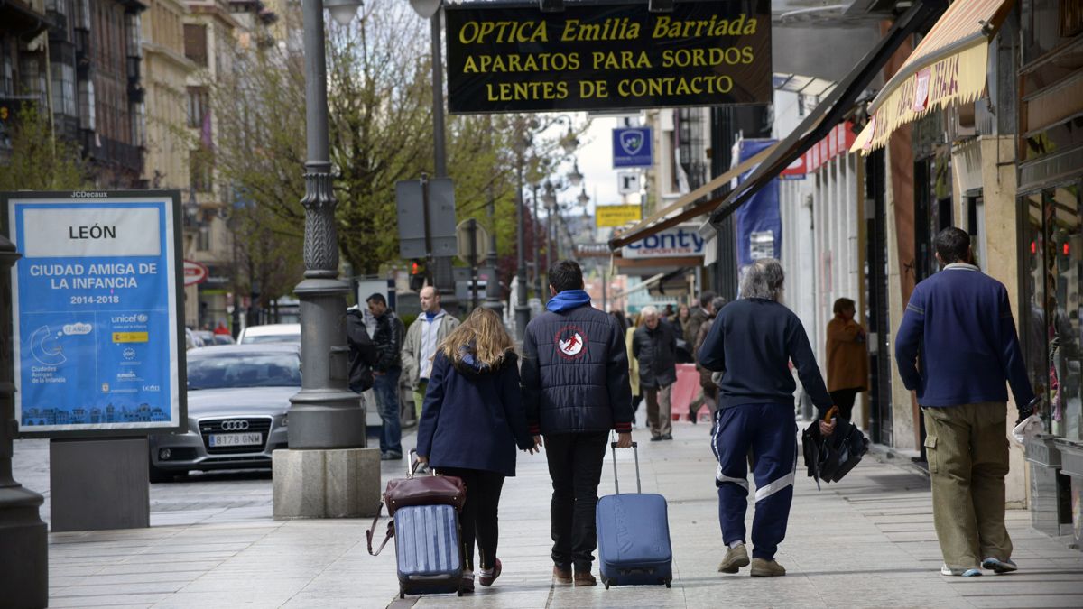 Dos jóvenes portan sus maletas por la avenida Ordoño II en una imagen de archivo. | MAURICIO PEÑA