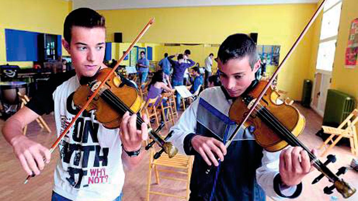Los hermanos Rubén y Víctor de Prado con los violines construidos por su padre.