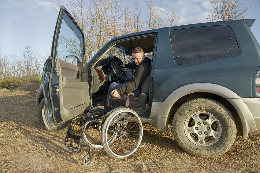 José Manuel subiendo a su cuatro por cuatro adaptado para poder seguir practicando la caza. Prepara la silla de ruedas para subirla al coche... y al monte.
